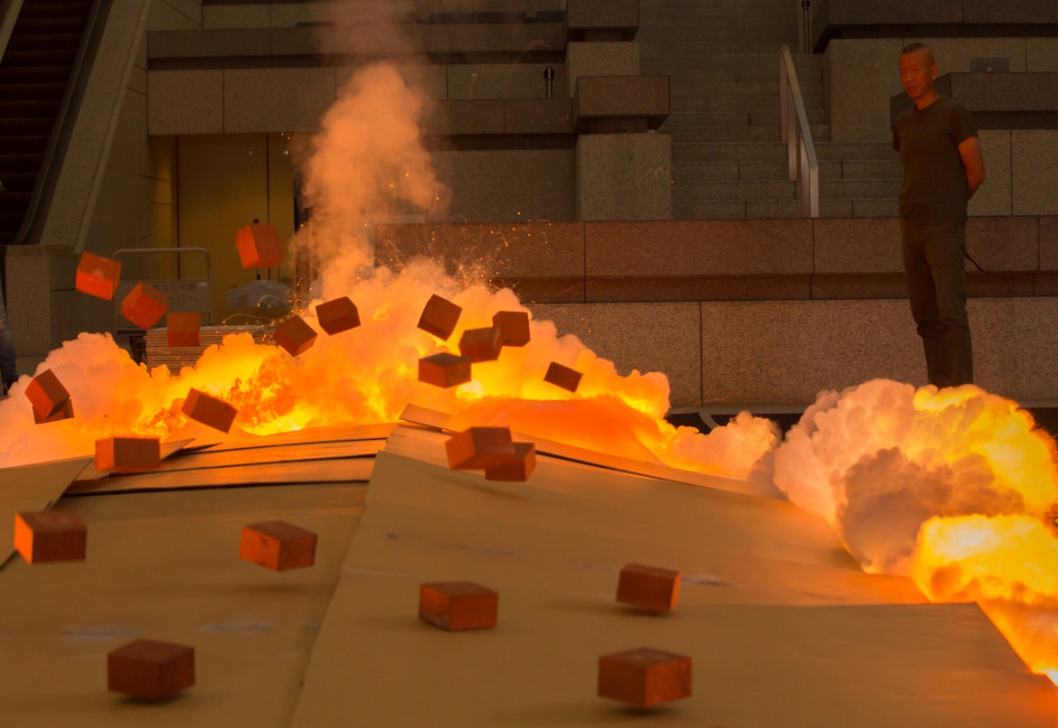 Cai Guo-Qiang igniting a gunpowder painting at the Yokohama Museum of Art, 2015. Photo by Kamiyama Yosuke, courtesy Cai Studio.