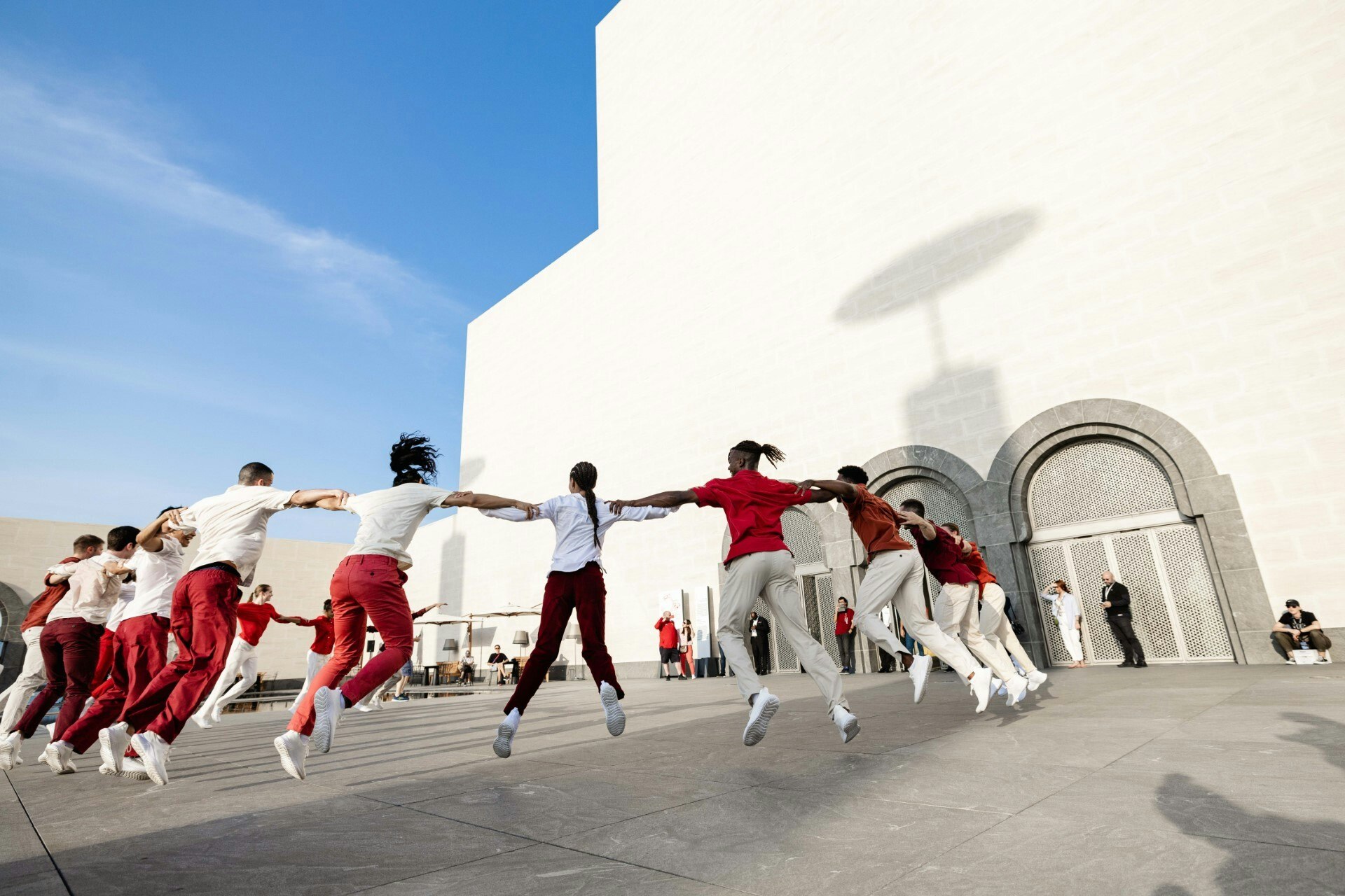 A photograph of a group of people dancing in a circle.