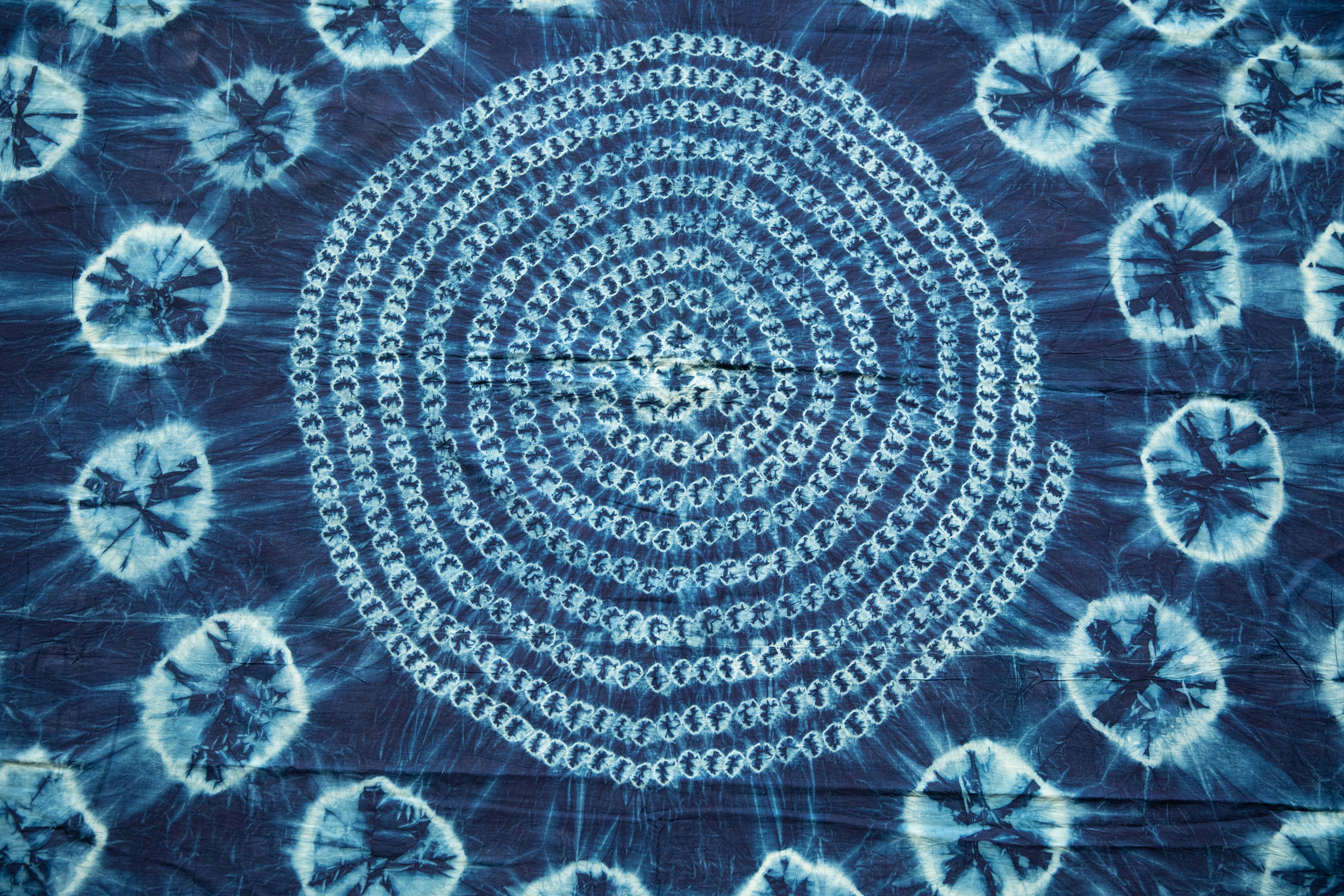 A photograph of an indigo and white tie-dyed textile.