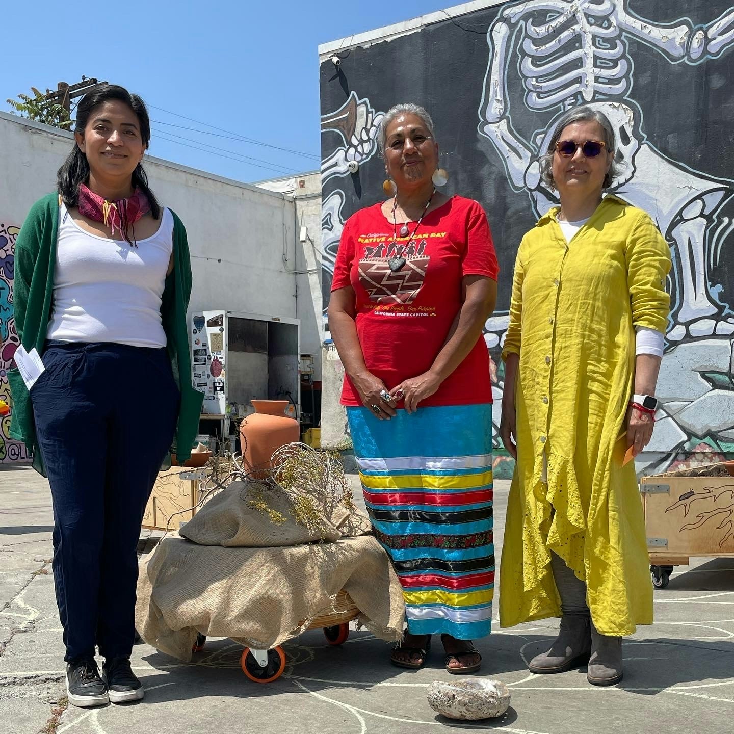 PST 2024 Sinks: Places We Call Home Artist and Scientist, Maru Garcia, Tongva and Chumash Land Steward, Tina Calderon and Artist, Beatriz Jaramillo take a moment to honor the commencement of the research of local contaminated land; through an intimate ceremony at Self Help Graphics & Art (May 2022). Photograph by Jennifer Cuevas. Courtesy of Self Help Graphics & Art. ©Self Help Graphics & Art.