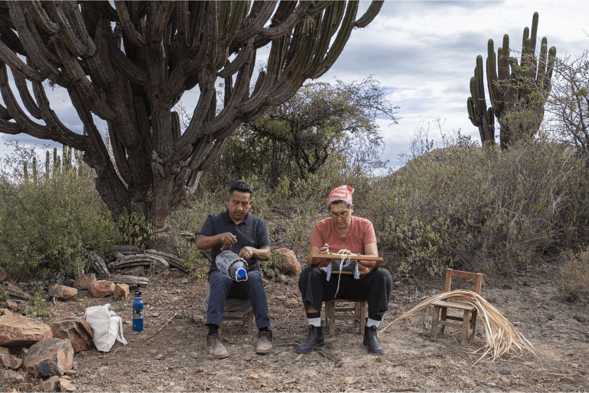 Artists Porfirio Gutiérrez and Tanya Aguiñiga talk and weave together in a field near Guiterrez' hometown in Teotítlan del Valle, Oaxaca. Photo Credit: Javier Lazo Gutiérrez